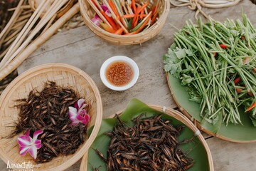 Fototapeta premium Unique culinary experience featuring roasted insects and fresh vegetables at a local market