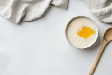 Warm porridge oats served with a slice of butter on a simple table setting