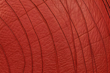 Close-up of Red Leather Texture Shows Detailed Reptile Skin Pattern with Subtle Shine.