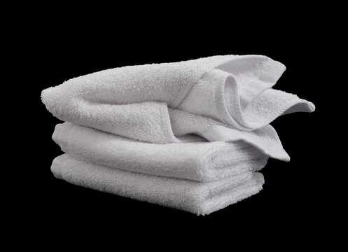 stack of messy white hand towels isolated