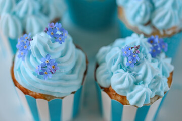 Blue Frosted Cupcakes with Edible Flowers.Cupcakes with flowers.Blue Cupcakes with Floral Topping. muffins with blue cream and forget-me-not flowers 