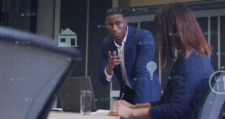 Image of media icons and data processing over diverse colleagues using laptop in office