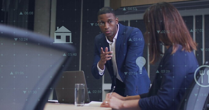 Image of media icons and data processing over diverse colleagues using laptop in office
