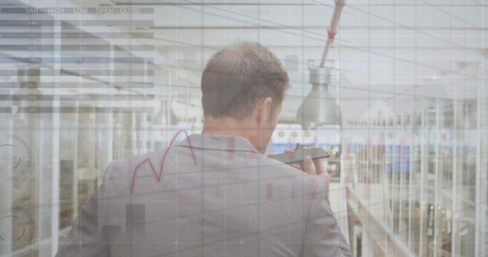 Image of graphs and charts over caucasian businessman talking on smartphone at airport