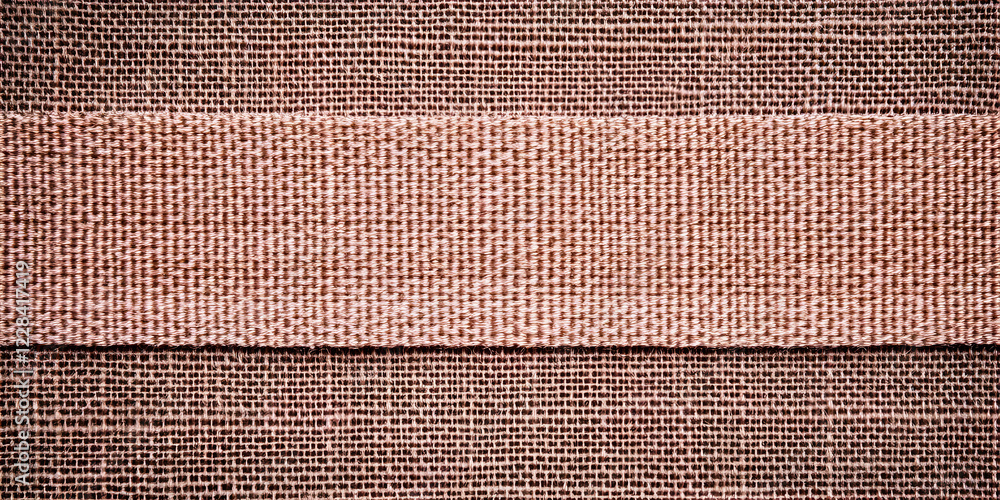 Poster Close-up of woven fabric displays a textured stripe of different weave across the rustic material.