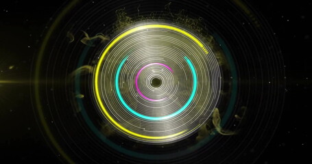 Image of colourful circles spinning over yellow shapes on black background
