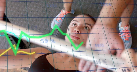 Image of diagrams over caucasian woman lifting weight bar at gym