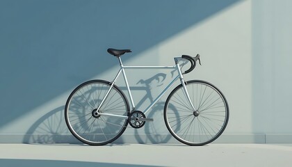 A white road bicycle leans against a pale blue wall