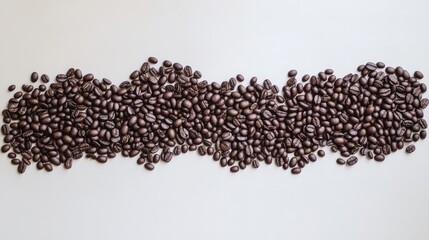 A clean composition of coffee beans on a white surface, arranged in a wave pattern with empty space.