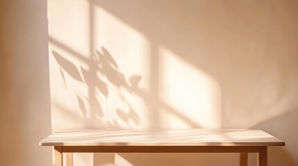 Sunlight illuminates wooden table, plant shadow on wall, interior backdrop