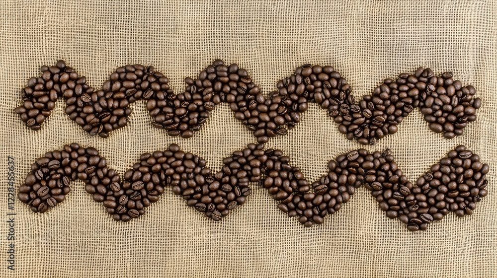 Poster coffee beans forming a zigzag pattern on a burlap cloth, leaving empty space for design.