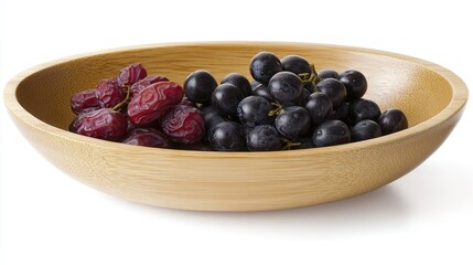 Red and black grapes in a wooden bowl on white background.