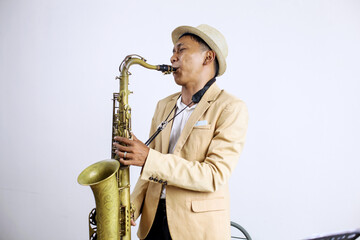 Young Male Playing Saxophone Isolated On White Background 