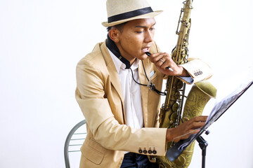 Young Musician Holding Saxophone While Finding Ideas To Make Music Instrument 