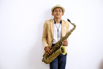Fashionable Asian Man Smiling While Holding Saxophone 