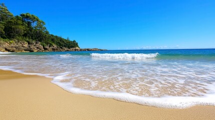 Obraz premium Serene Beach Scene with Gentle Waves and Clear Blue Skies