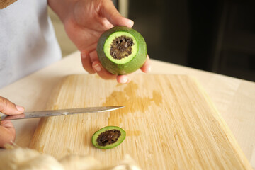A rotten avocado on a white background.