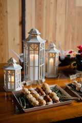 Elegant appetizer display featuring warm pastries and decorative lanterns at a cozy gathering