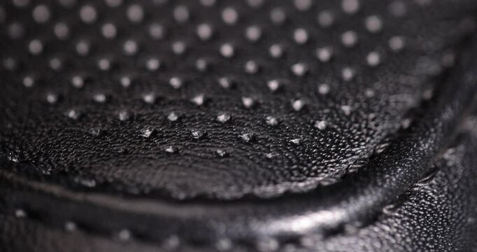 black leather for the production of shoes close up, treated leather with perforation to give a beautiful appearance