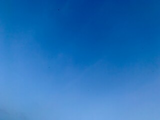 A view of a bright blue sky with white clouds, suitable for the background