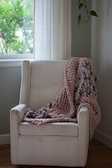 Dirty spots on the upholstery of a beige armchair . Dirt on upholstered furniture. Dirty chair in the interior of the room