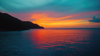 Fototapeta premium Breathtaking Sunset over Calm Ocean and Silhouette of Coastline