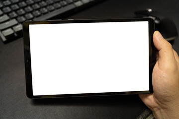 Blank screen tablet on desk. Digital tablet with isolated screen in male hands. digital tablet with empty display.