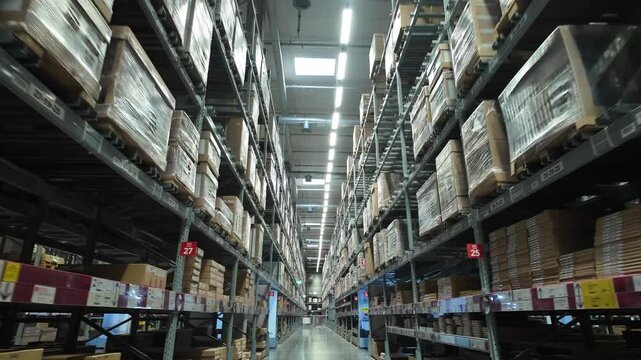Large warehouse interior showcasing organization with pallets, shelves, and effective lighting for industrial storage solutions.