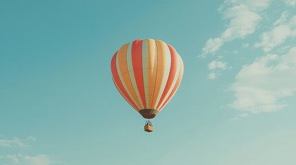 Naklejka premium Colorful Hot Air Balloon Gliding Through a Clear Blue Sky