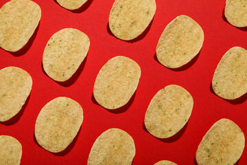 Crispy potato chips on a red background