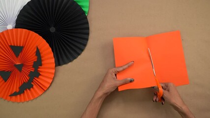 Making orange paper rosettes for Halloween decorations with crafting theme - Powered by Adobe