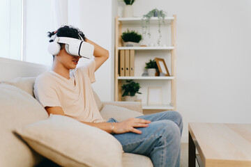 Virtual reality headset usage, young man relaxing on a sofa in a modern living room, light colors, modern decor, immersive technology engagement, contemporary lifestyle