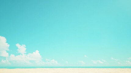 Serene beach scene with clear blue sky and soft waves gently lapping at the shore