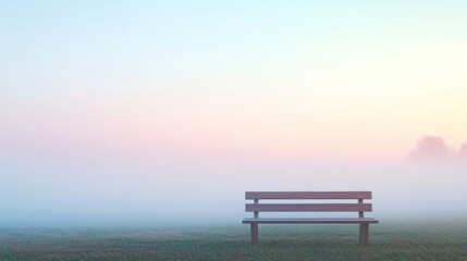 Tranquil Wooden Bench in Misty Landscape at Sunrise