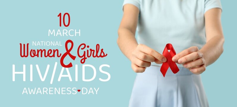Woman with red ribbon on light blue background, closeup. National Women and Girls HIV/AIDS Awareness Day
