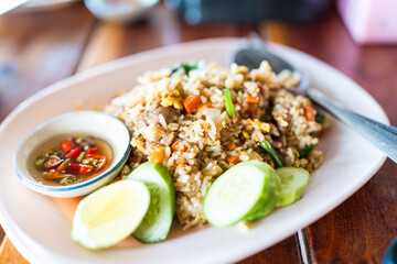 Thai dish of Khao pad moo fried rice served together with chilli in fish sauce © Dontree