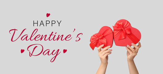 Female hands with gift boxes on white background. Valentine's Day celebration