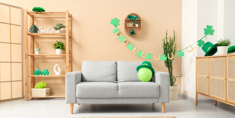 Interior of festive living room with grey sofa and decorations for St. Patrick's Day celebration