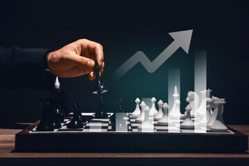 Man playing chess at table on dark background, closeup