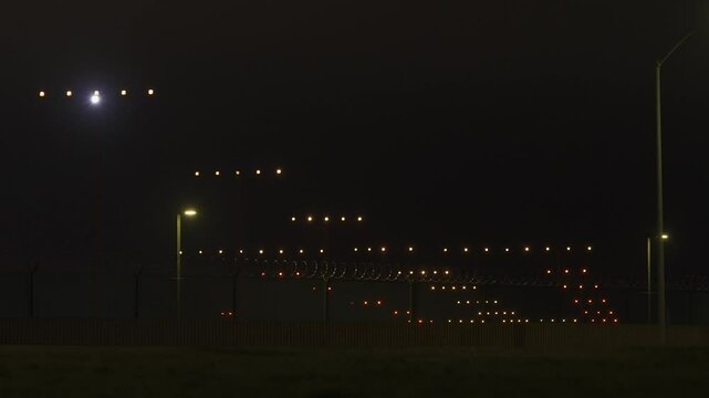 Large Passenger Airplane Lands at Night - Runway View