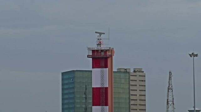 Chennai Lighthouse in marina beach with JM Marina, marine towers, light pole and signal tower at Marina Beach, Mylapore, Chennai, Tamil Nadu, india. day time, close up shot, 4k