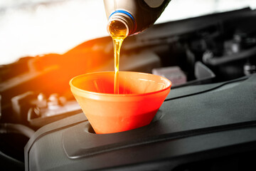 Refueling and pouring oil quality into the engine motor car Transmission and Maintenance Gear...