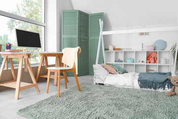 Interior of children's room with bed and study table