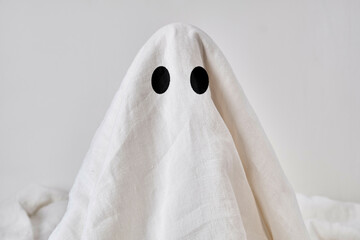 Sheet ghost in white room.
