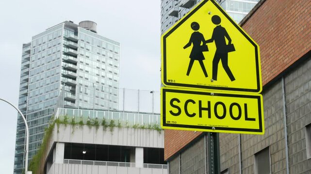 School zone yellow road sign, pedestrian crossing. Children safety on street, New York City. Transport and education symbol, USA . Traffic roadsign in Queens, Long Island, Hunters point.
