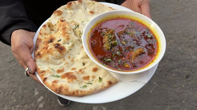 Featuring of large garlic naan with dhaniya mutton with oily gravy.