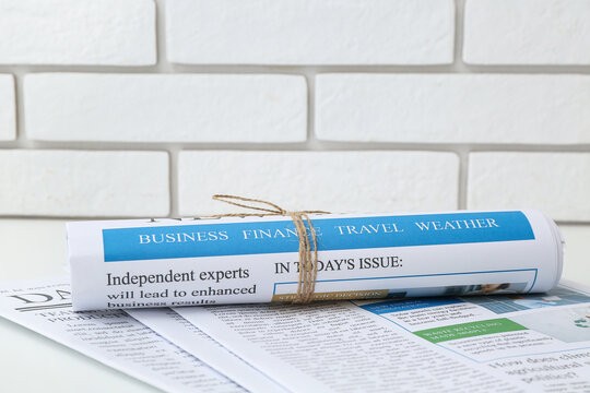 Different newspapers on white table