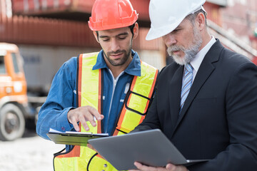 Senior businessman manager and male worker working at container cargo site control loading...