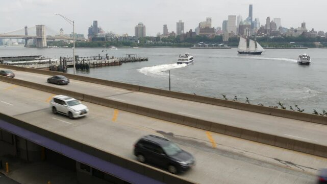 New York City waterfront road, Financial district, Manhattan Downtown riverfront from Elevated Acre. Highway along East river, cars on waterside FDR drive. Brooklyn Bridge, United States architecture