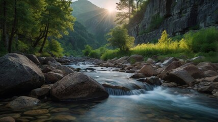 Majestic mountain stream with rocky banks and sun shining through the trees